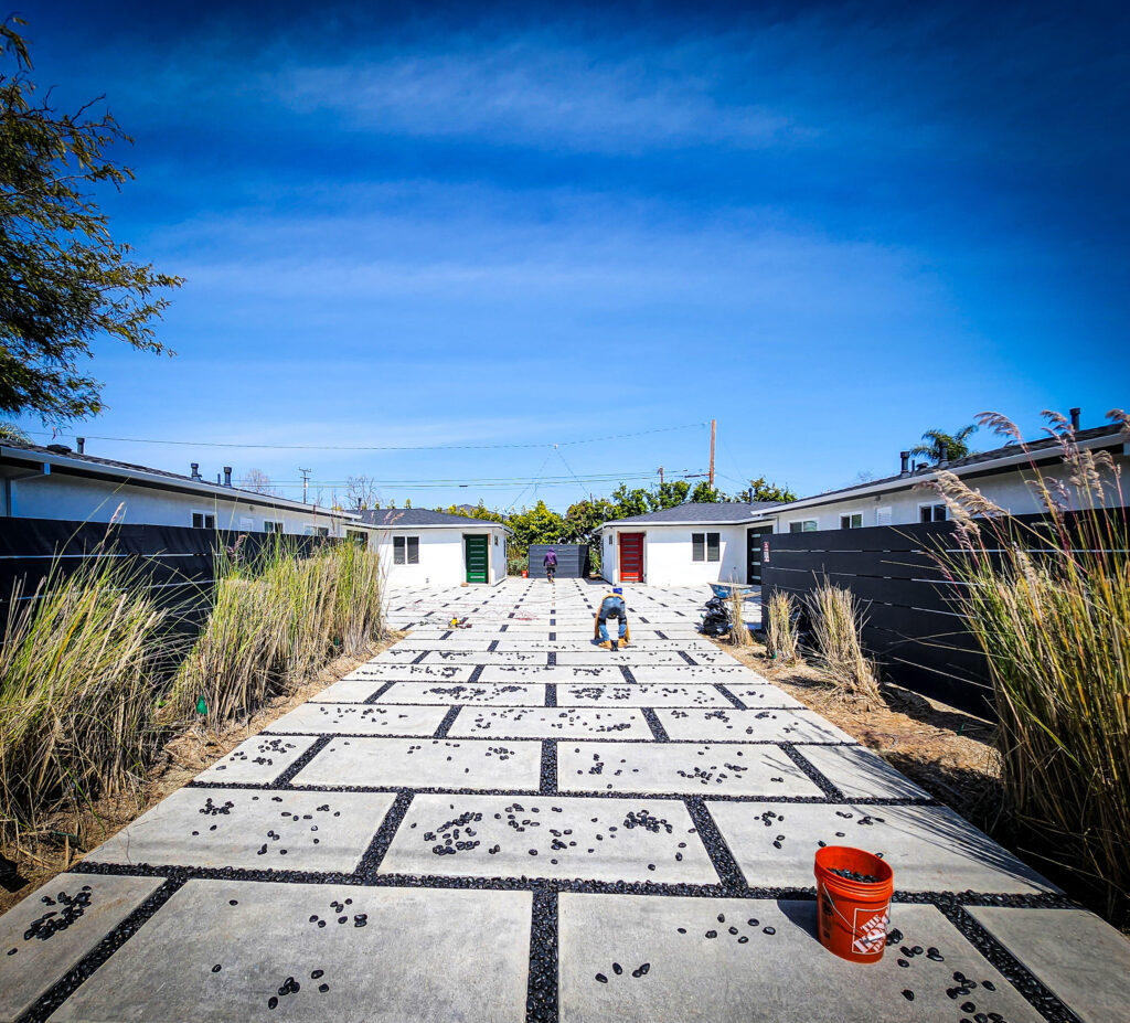 Concrete paver driveway with pebble joints and ornamental grasses &mdash; Costa Mesa landscape project by Abode Landscaping