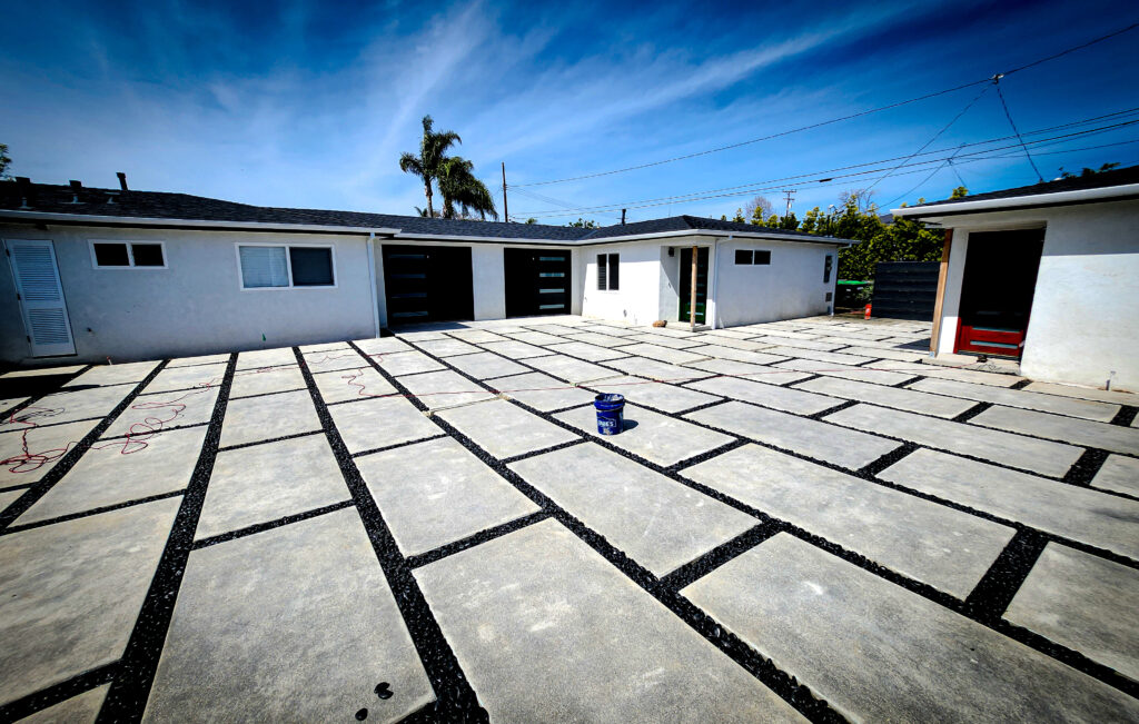 Wide concrete paver driveway with pebble joints &mdash; Costa Mesa landscape project by Abode Landscaping
