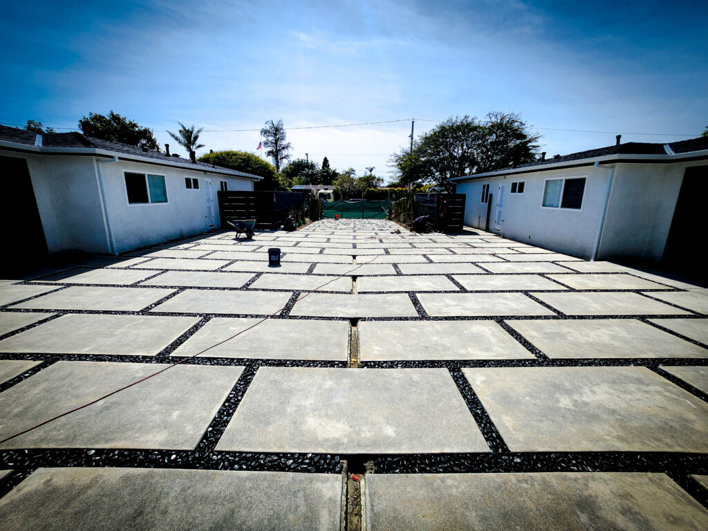 Finished concrete paver driveway between garages &mdash; Costa Mesa landscape project by Abode Landscaping
