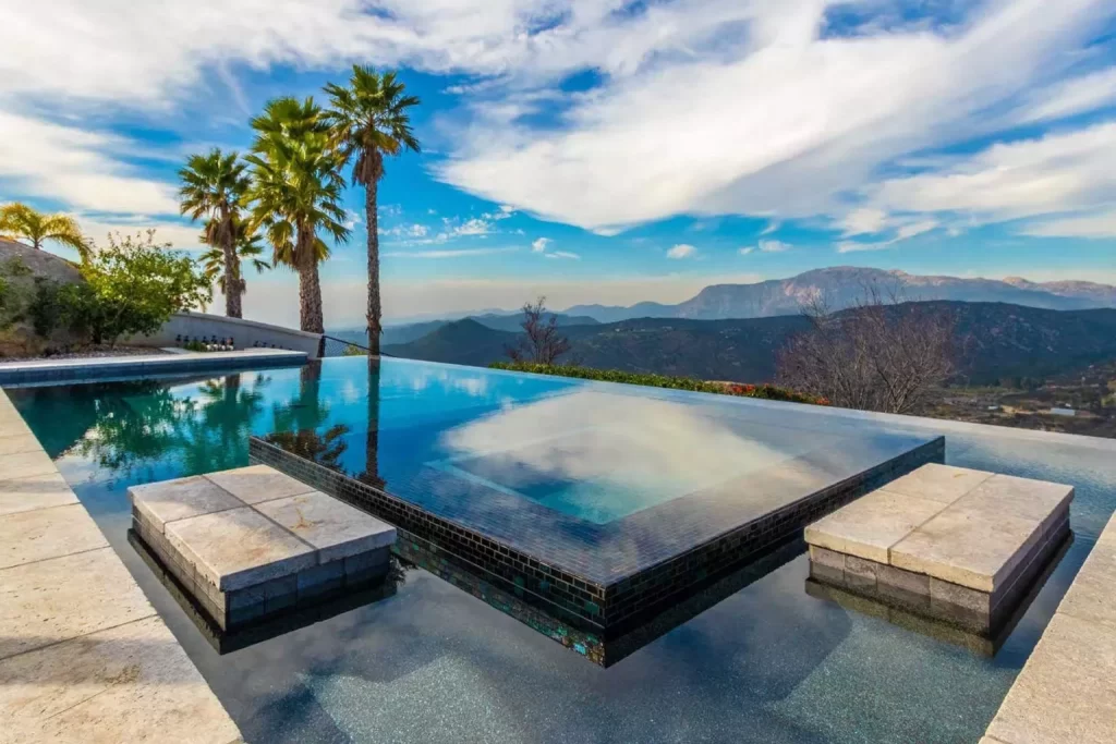 Stunning rim flow spa and infinity edge pool in southern California. With Pebble Tec